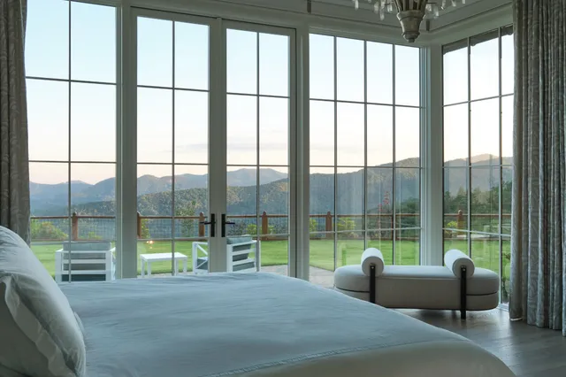 a view of a house with pool and sitting area