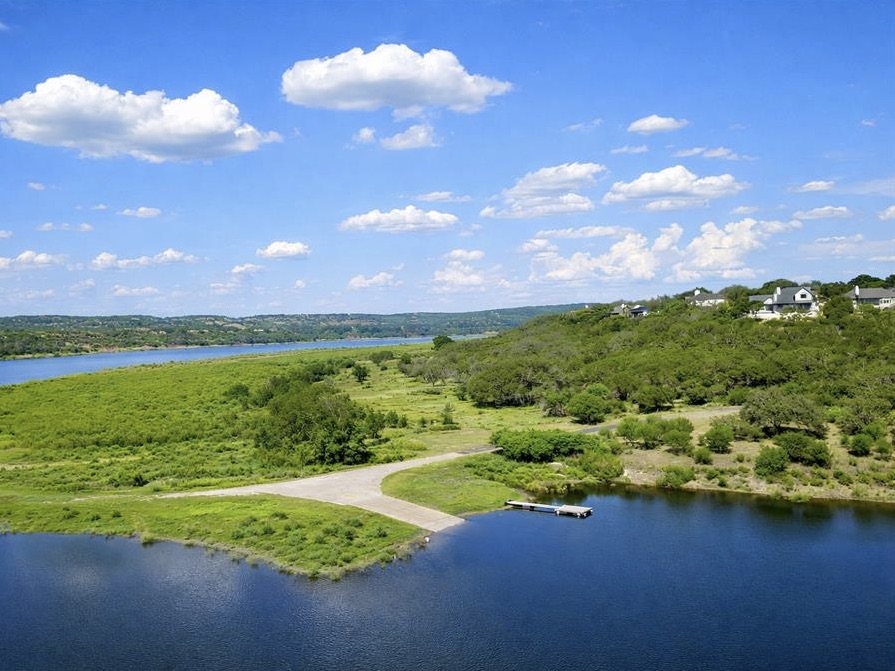 300 Wesley Ridge Drive Spicewood, TX 78669 - Photo 27 of 40 a view of a lake with a big yard