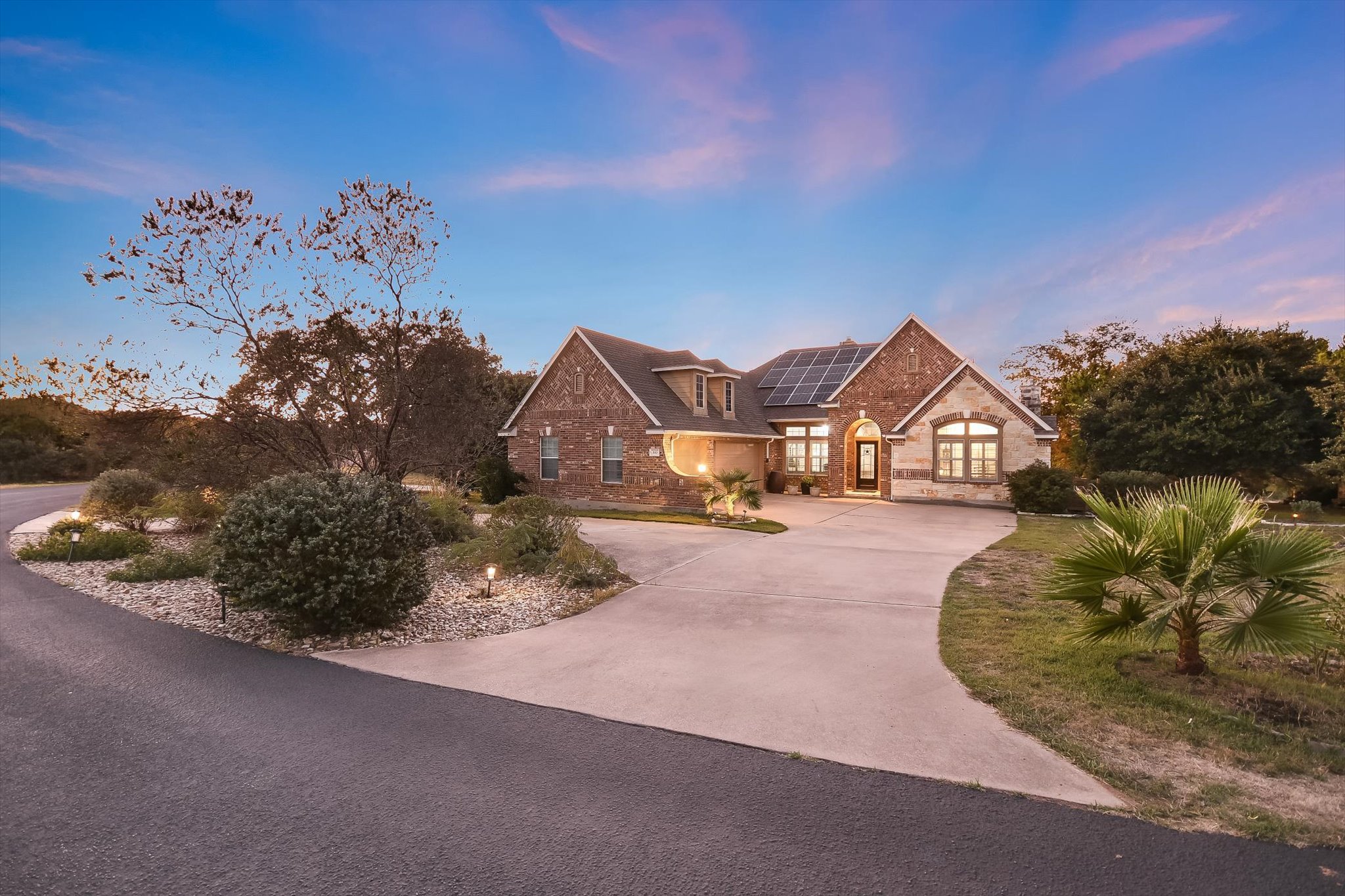 300 Wesley Ridge Drive Spicewood, TX 78669 - Photo 39 of 40 a front view of a house with a yard and garage