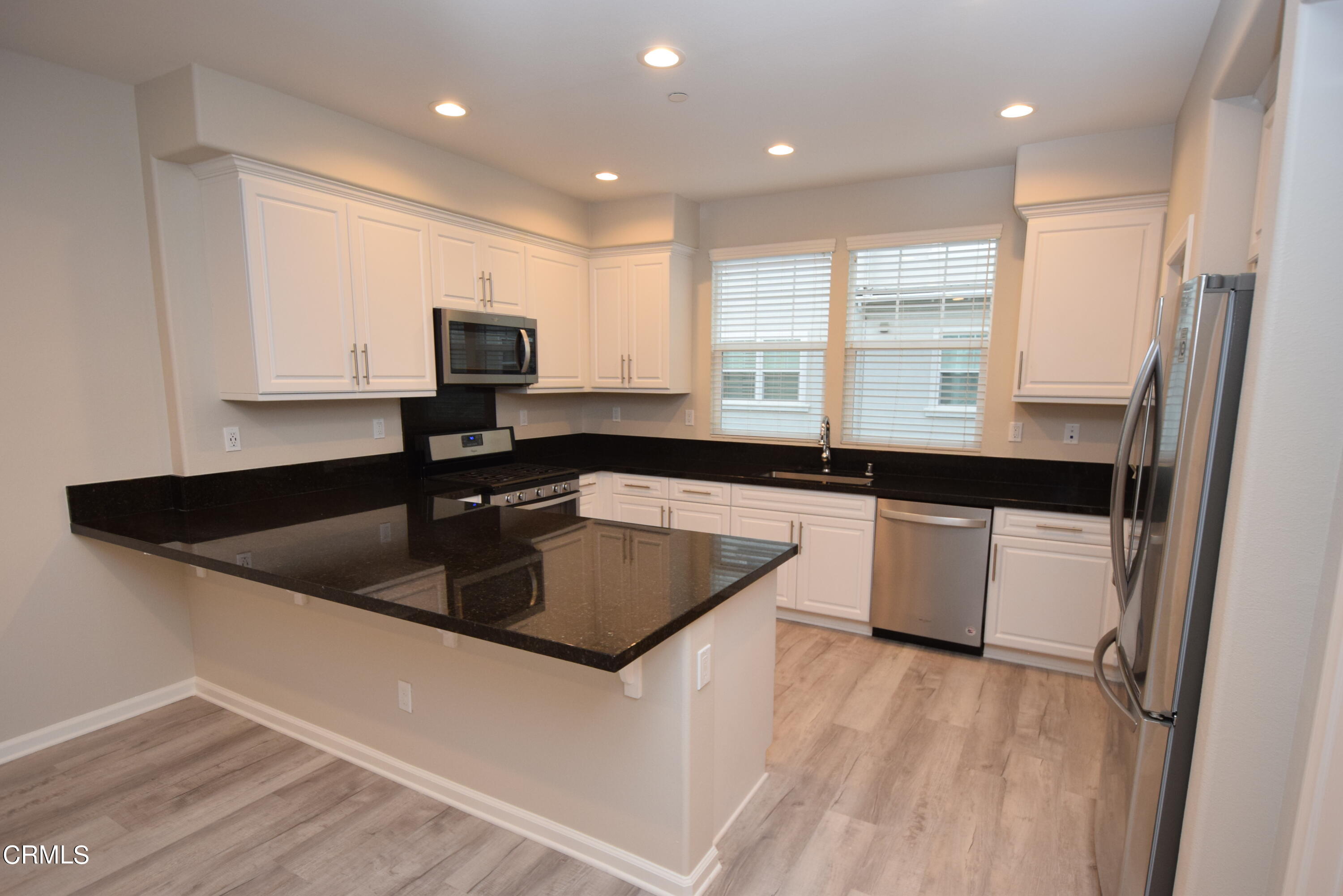 3755 Islander Walk Oxnard, CA 93035 - Photo 6 of 20 a kitchen with granite countertop a sink a stove and refrigerator