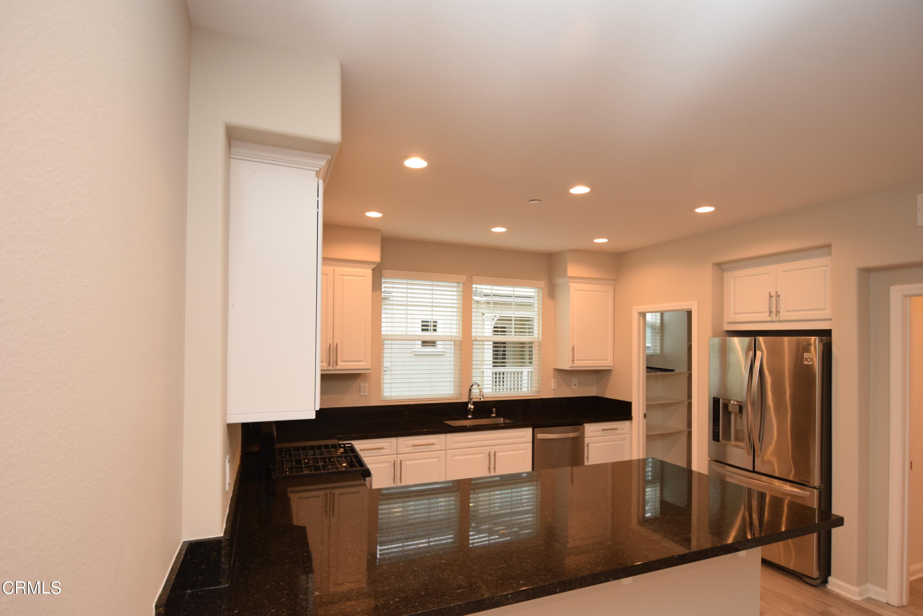 3755 Islander Walk Oxnard, CA 93035 - Photo 7 of 20 a kitchen with stainless steel appliances granite countertop a refrigerator and a stove