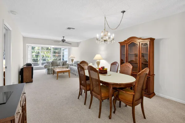 a view of a dining room with furniture and chandelier
