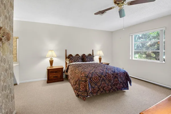a bathroom with a granite countertop shower a toilet and a bathtub