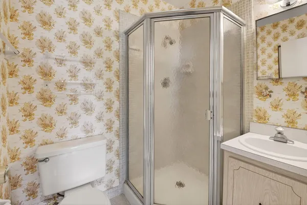 an aerial view of residential houses with yard and lake view