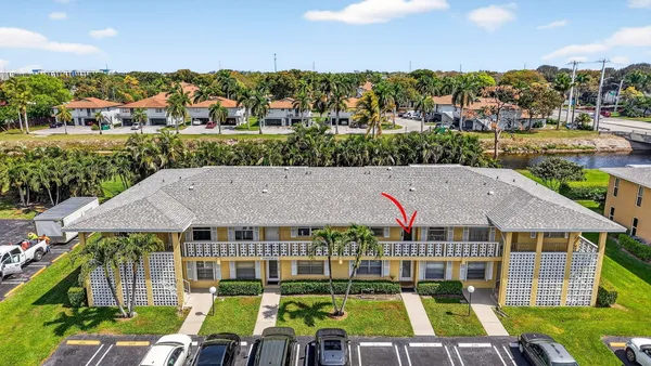 aerial view of a house with a yard and potted plants