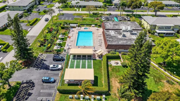 an aerial view of multiple houses with yard