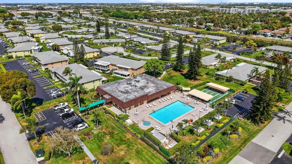 a view of swimming pool is middle in the garden