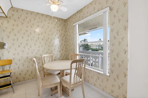 a kitchen with white cabinets and appliances