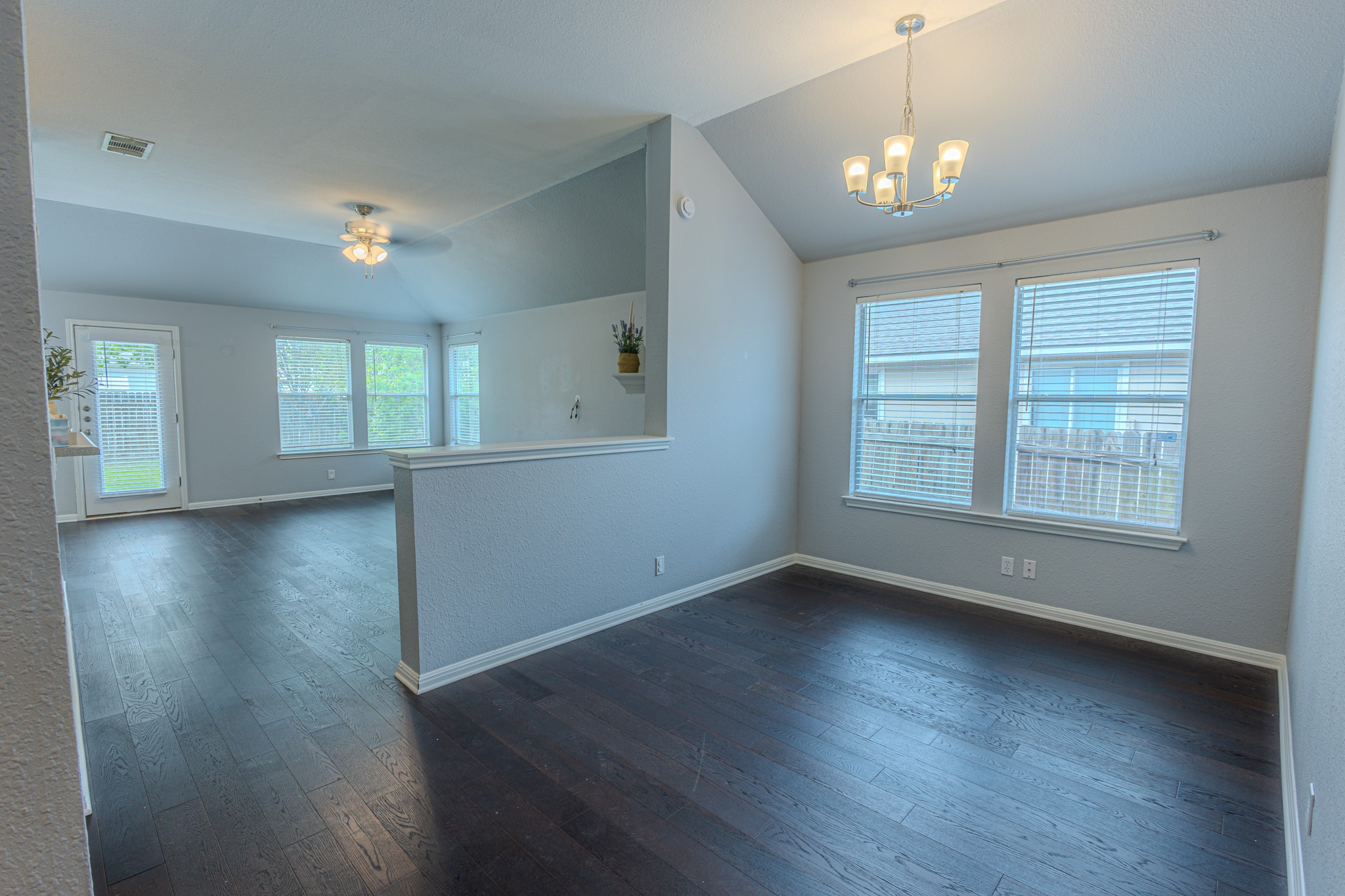 208 Discovery Kyle, TX 78640 - Photo 17 of 31 Open-concept living area with dark wood-finish flooring throughout