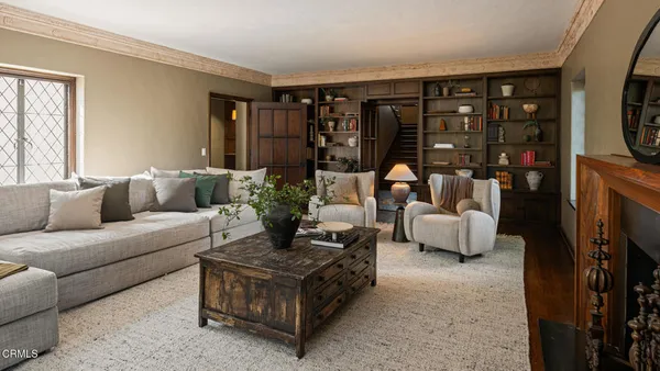 a living room with furniture and a potted plant