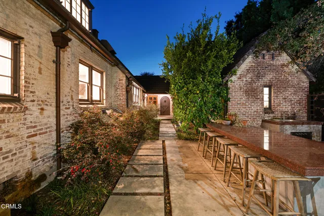 a front view of a house with a garden