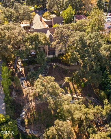 a wooden bench sitting in the middle of a yard