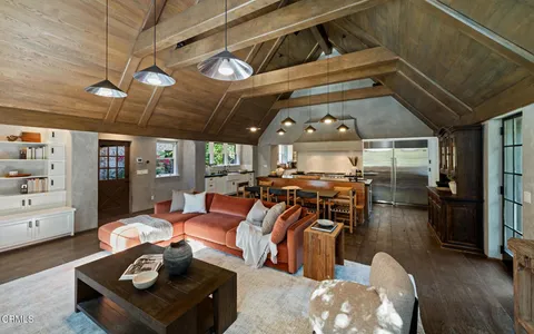 a living room with dining table and a fireplace