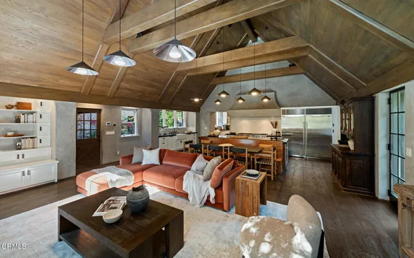 a living room with dining table and a fireplace