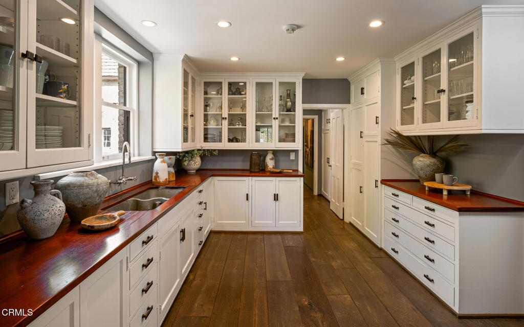 1146 Shenandoah Road San Marino, CA 91108 - Photo 10 of 38 a large kitchen with stainless steel appliances a large counter top a stove a sink and a refrigerator