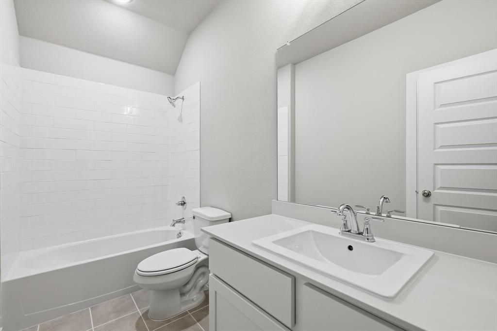 14908 Dust Storm Trail Haslet, TX 76052 - Photo 12 of 20 a bathroom with a sink a toilet and shower