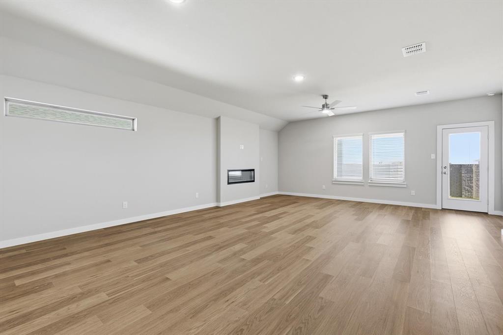 14908 Dust Storm Trail Haslet, TX 76052 - Photo 7 of 20 a view of empty room with wooden floor and fan