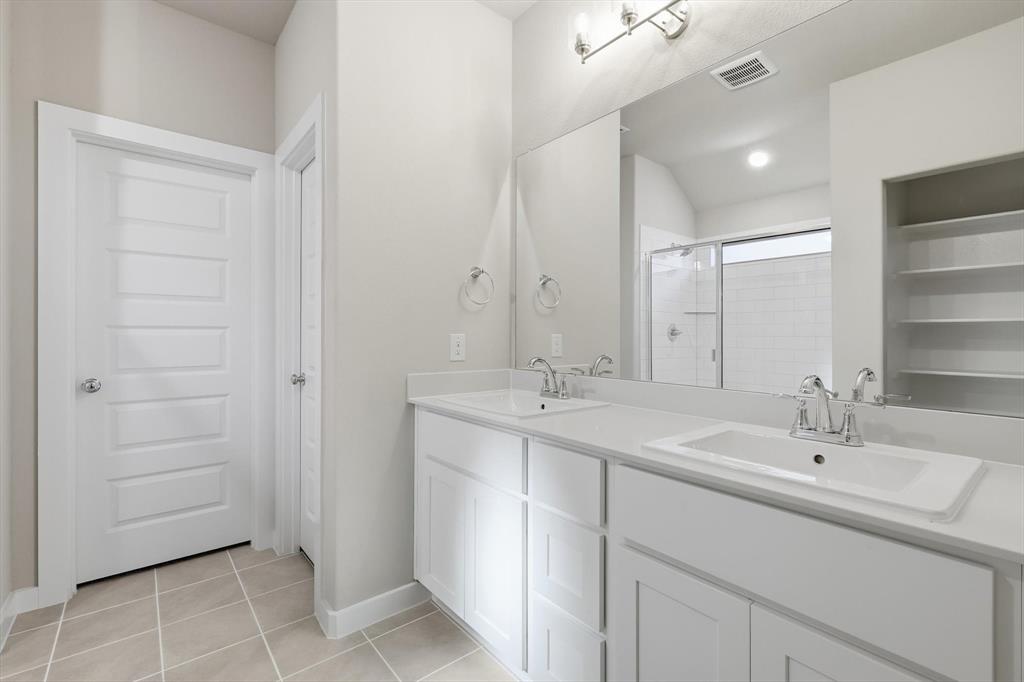 14908 Dust Storm Trail Haslet, TX 76052 - Photo 9 of 20 a bathroom with a sink and a mirror