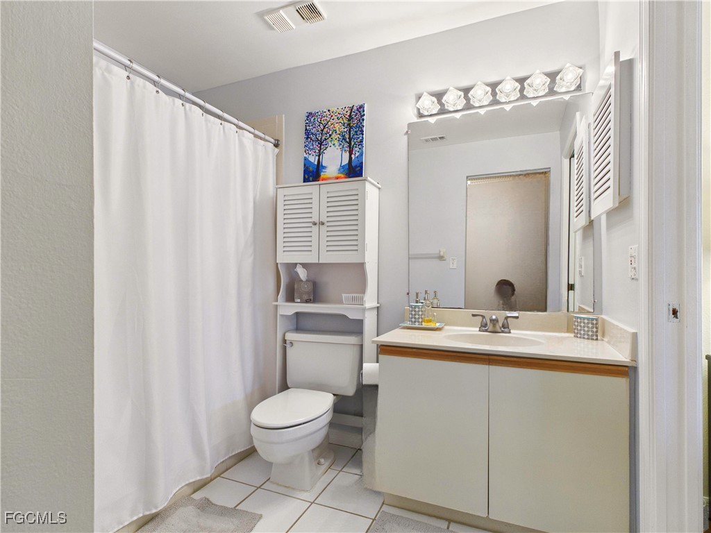 1290 Yesica Ann Circle, Unit G204 Naples, FL 34110 - Photo 16 of 21 a bathroom with a sink a toilet and shower