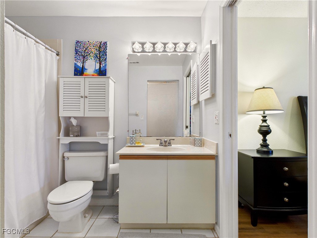 1290 Yesica Ann Circle, Unit G204 Naples, FL 34110 - Photo 17 of 21 a bathroom with a sink toilet and mirror