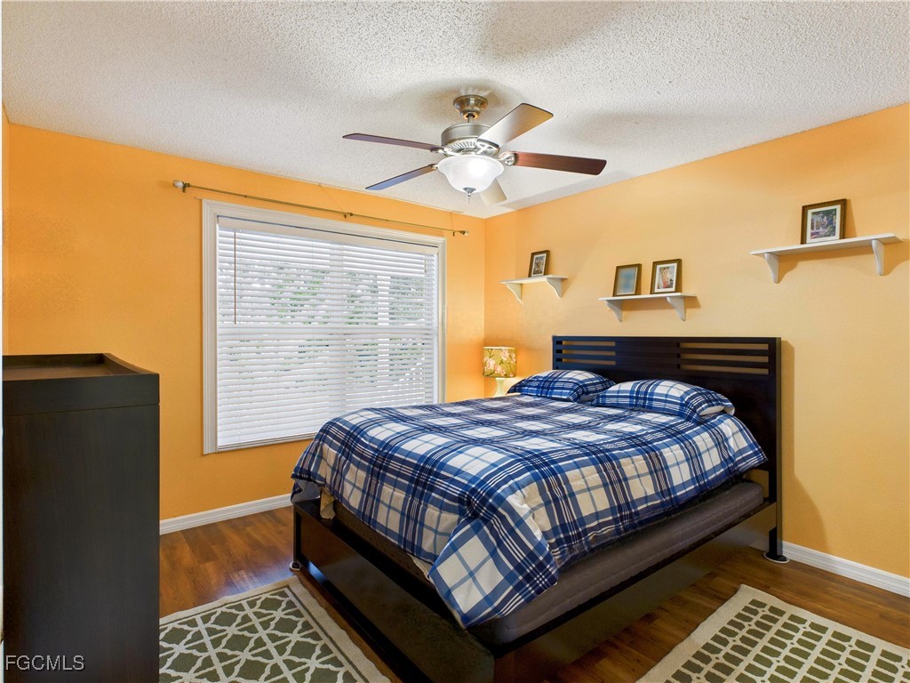 1290 Yesica Ann Circle, Unit G204 Naples, FL 34110 - Photo 5 of 21 a bedroom with a bed lamp and a window