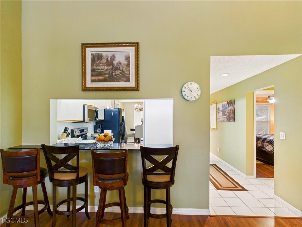 1290 Yesica Ann Circle, Unit G204 Naples, FL 34110 - Photo 8 of 21 a dining room with a table and chairs