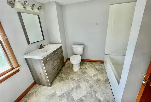 a bathroom with a toilet sink and a mirror