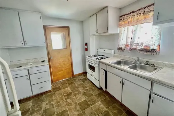 a kitchen that has a sink and a stove