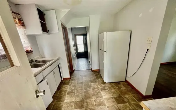 a view of a kitchen from a hallway