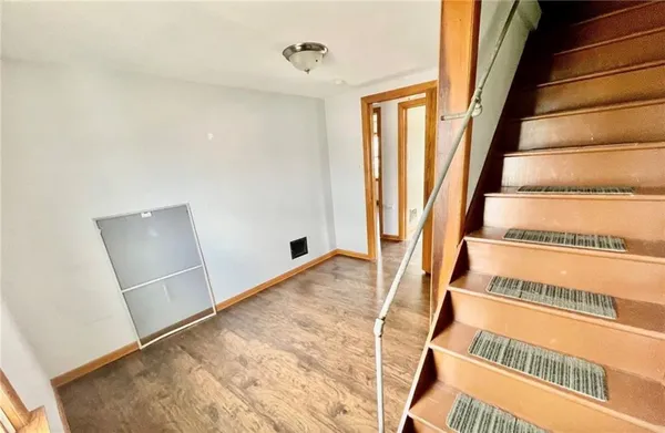 a view of staircase with white walls and a window