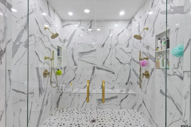 a bathroom with mirror and shower