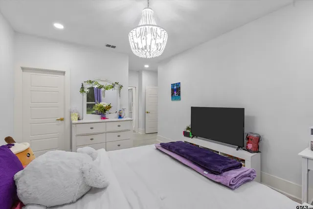 a bedroom with a bed and flat screen tv