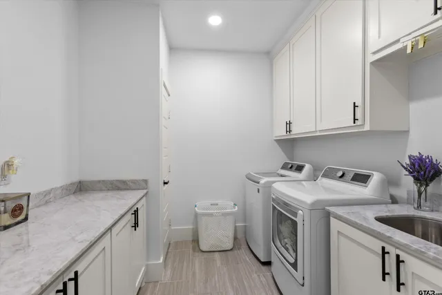 a utility room with sink dryer and washer