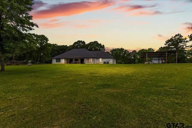 a view of outdoor space with deck and yard