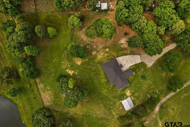 an aerial view of residential houses with outdoor space and lake view