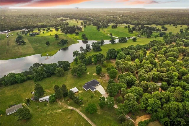 a view of a yard with wooden fence