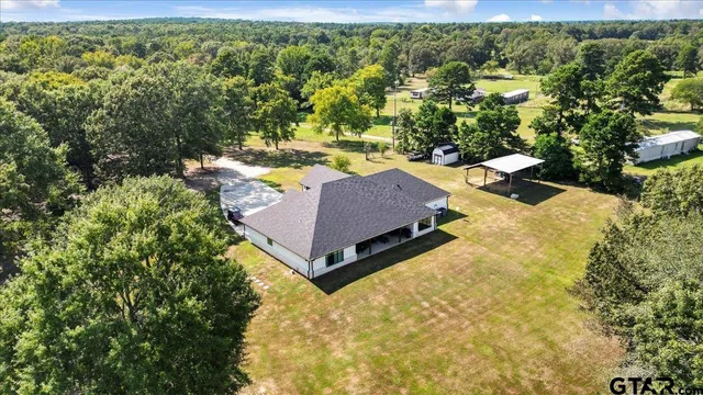 an aerial view of a house with yard swimming pool and outdoor seating