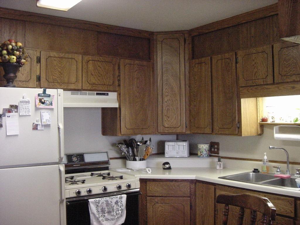 301 Southwest 45th Avenue Amarillo, TX 79110 - Photo 13 of 19 a kitchen with a sink a stove a refrigerator and cabinets