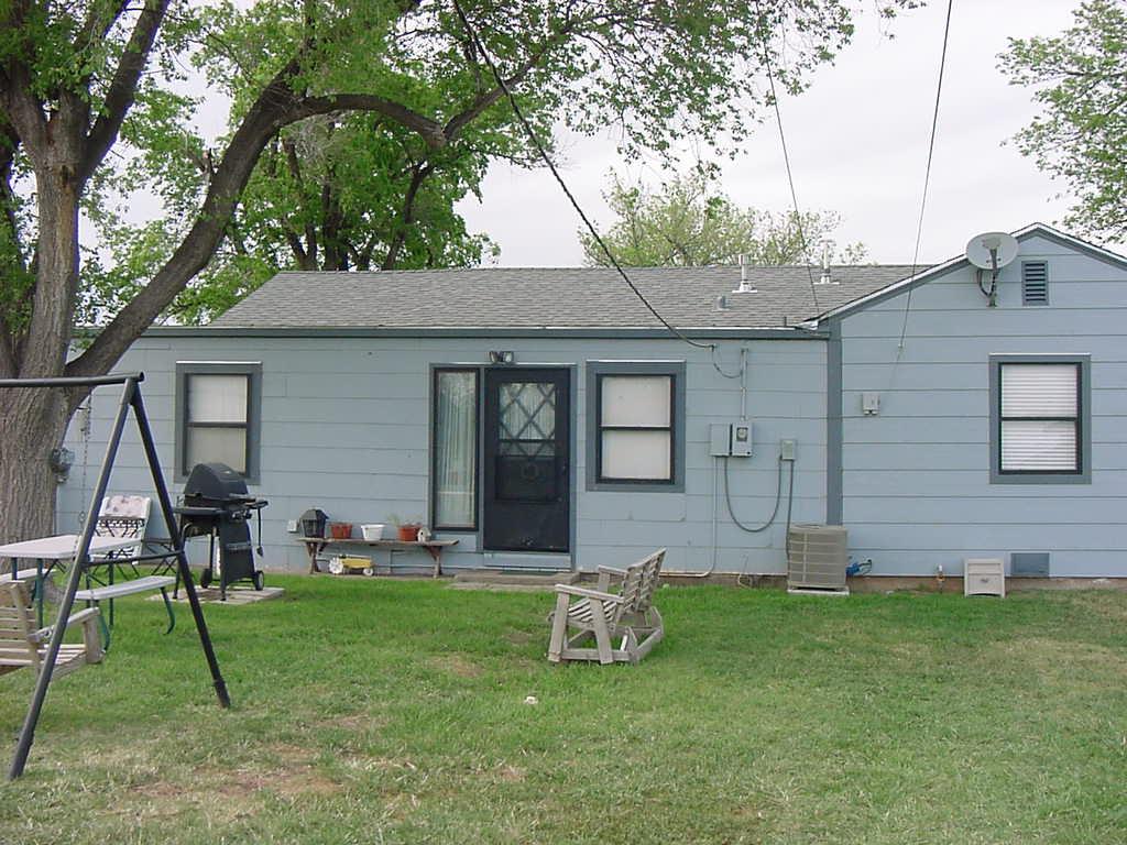301 Southwest 45th Avenue Amarillo, TX 79110 - Photo 6 of 19 a view of a backyard with table and chairs and wooden fence