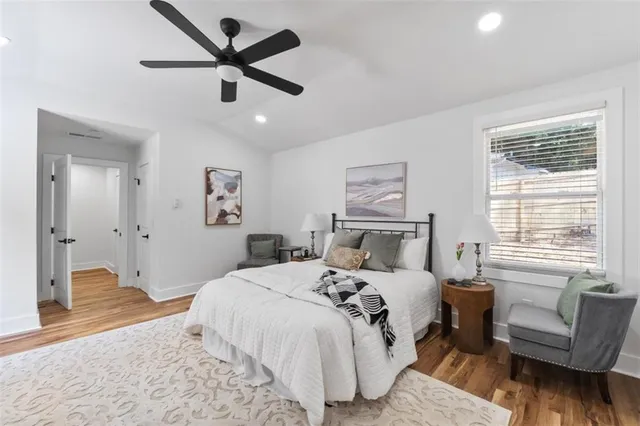 a bedroom with a bed couches and a couch