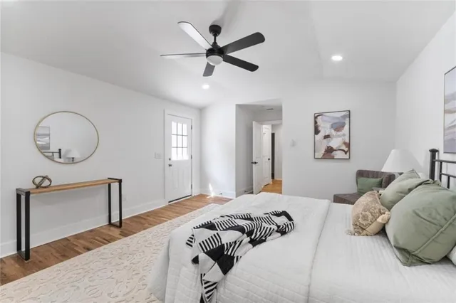 a bedroom with a large bed and a chandelier