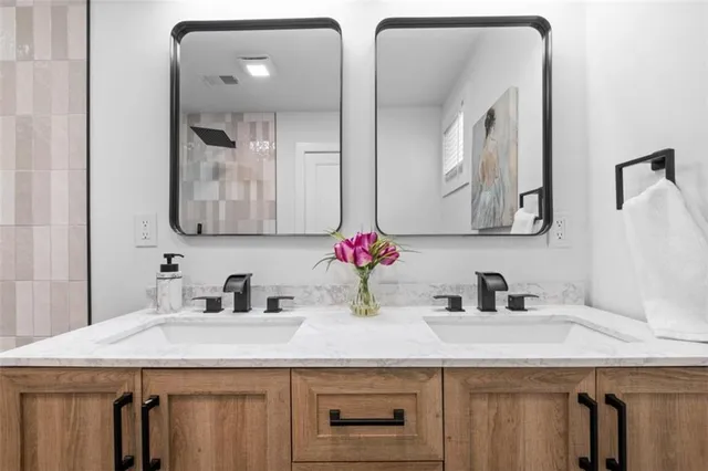 a bathroom with double sink and a mirror