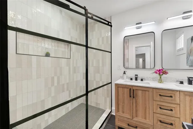 a bathroom with a double vanity sink mirror and