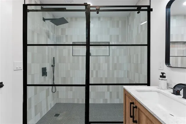 a bathroom with a shower and a sink