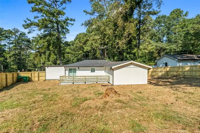 a white house that has a tree in front of it