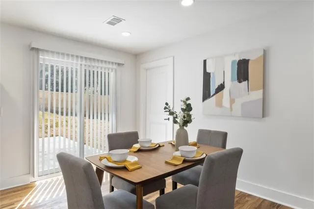 a dining room with furniture and wooden floor