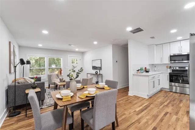 a living room with stainless steel appliances kitchen island granite countertop furniture and a kitchen view