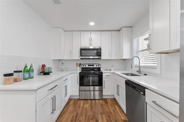 a kitchen with a sink cabinets and stainless steel appliances