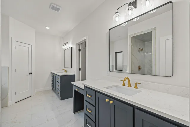 a bathroom with a double vanity sink mirror and