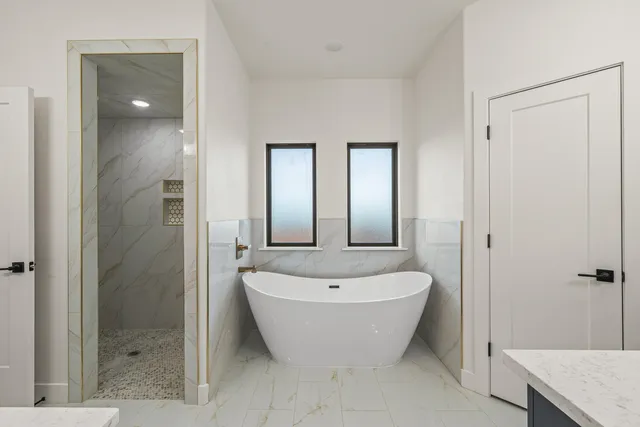 a spacious bathroom with a bathtub and shower